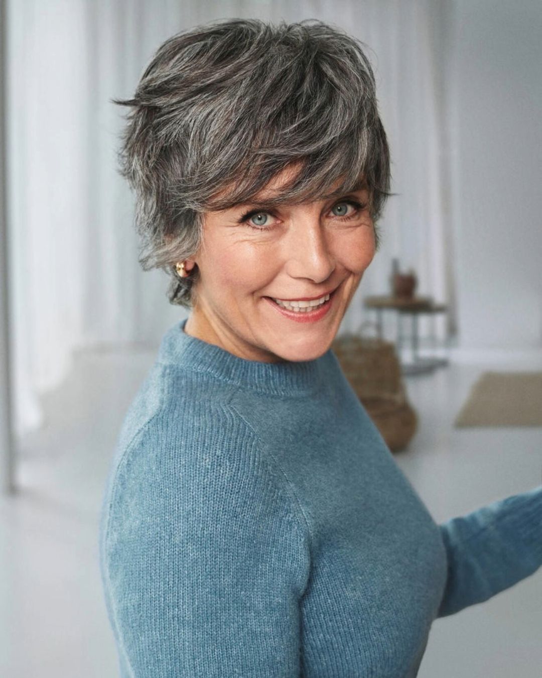 mature lady with short layered hair cut that is salt and pepper coloured mature lady with short layered hair cut that is salt and pepper coloured